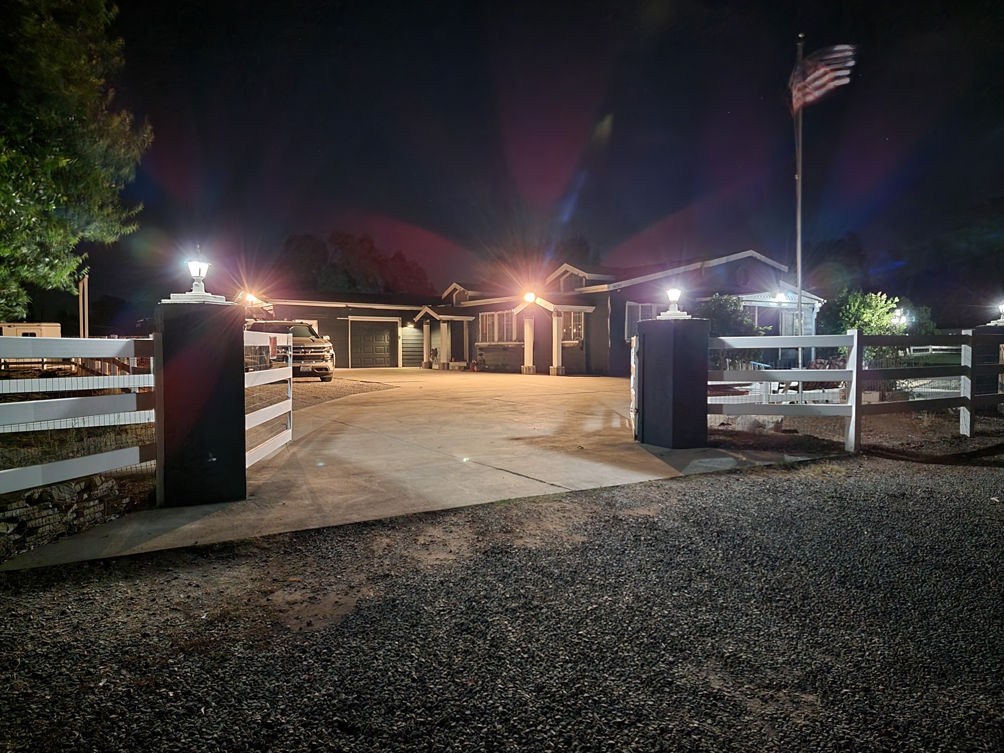 The home at twilight with warm porch lighting